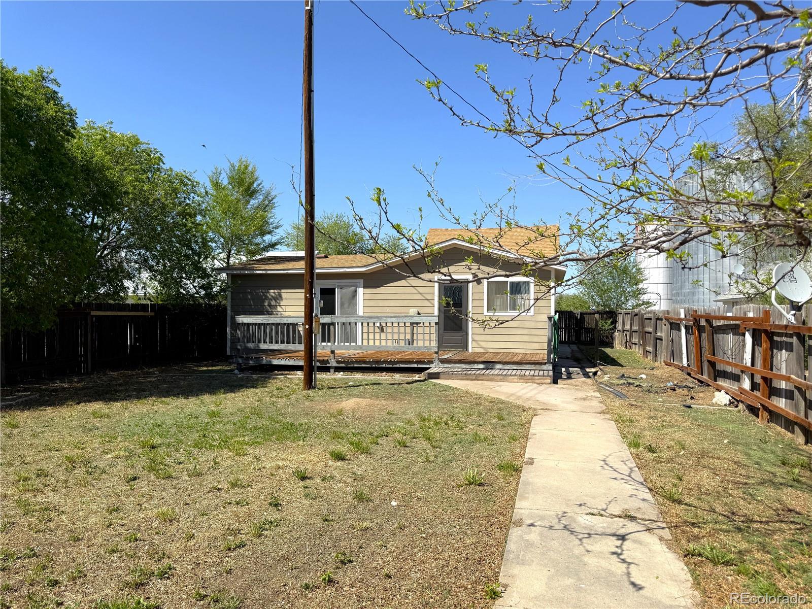 426 3rd Street Hugo, CO 80821 - Photo 24 of 34 a front view of a house with a yard