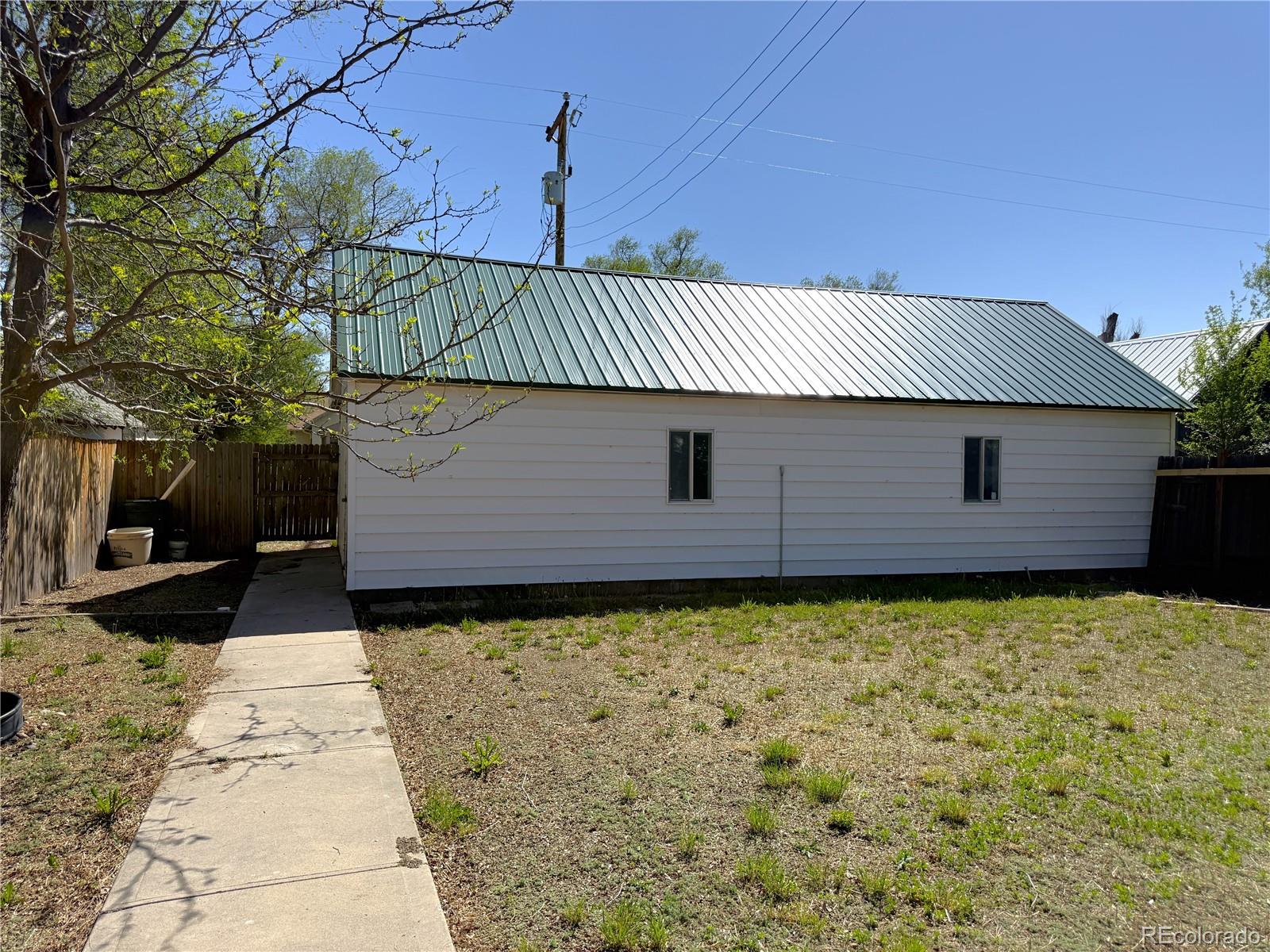426 3rd Street Hugo, CO 80821 - Photo 26 of 34 a front view of a house with a garden