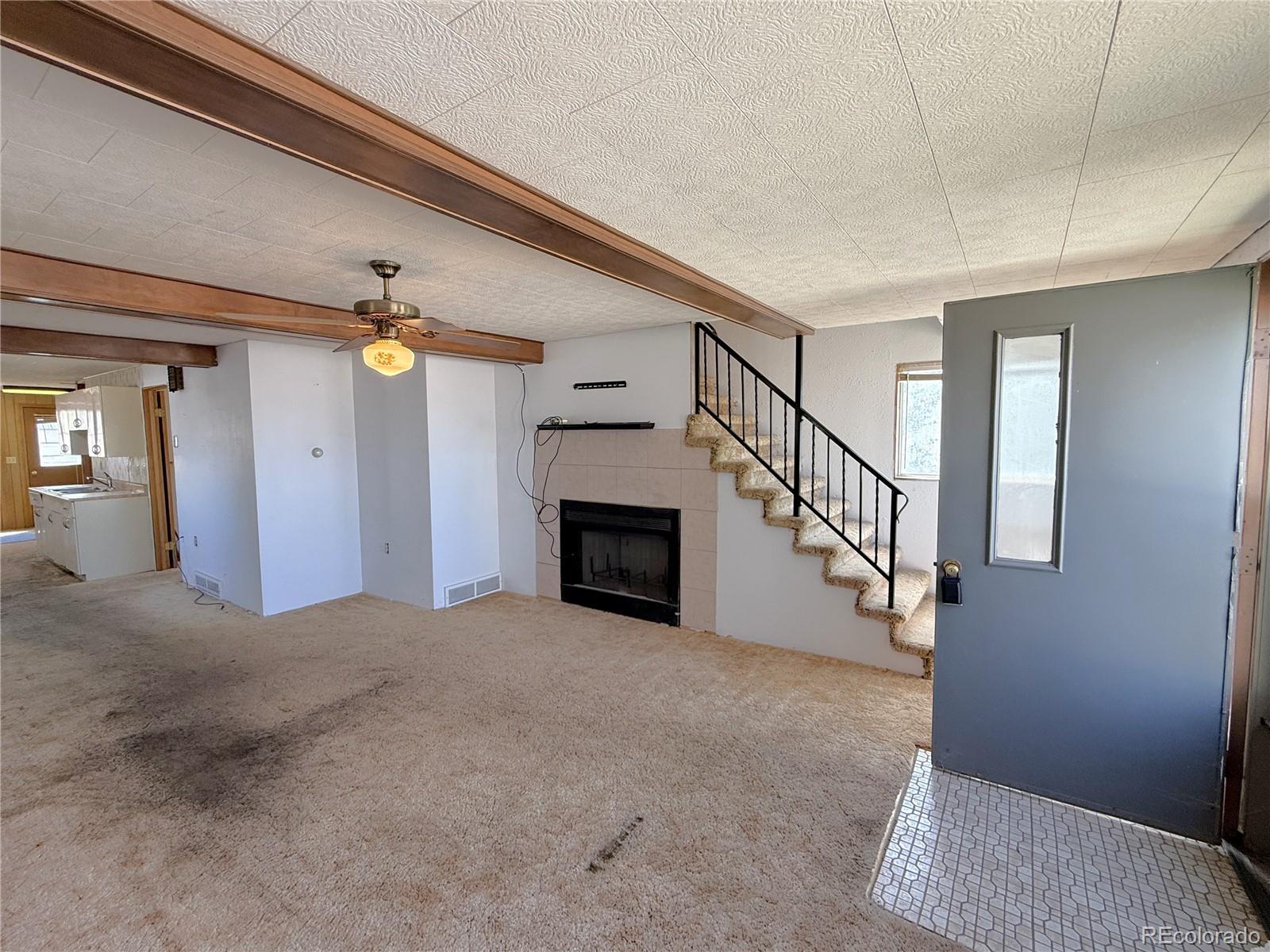 426 3rd Street Hugo, CO 80821 - Photo 4 of 34 a view of a hallway with wooden floor and staircase