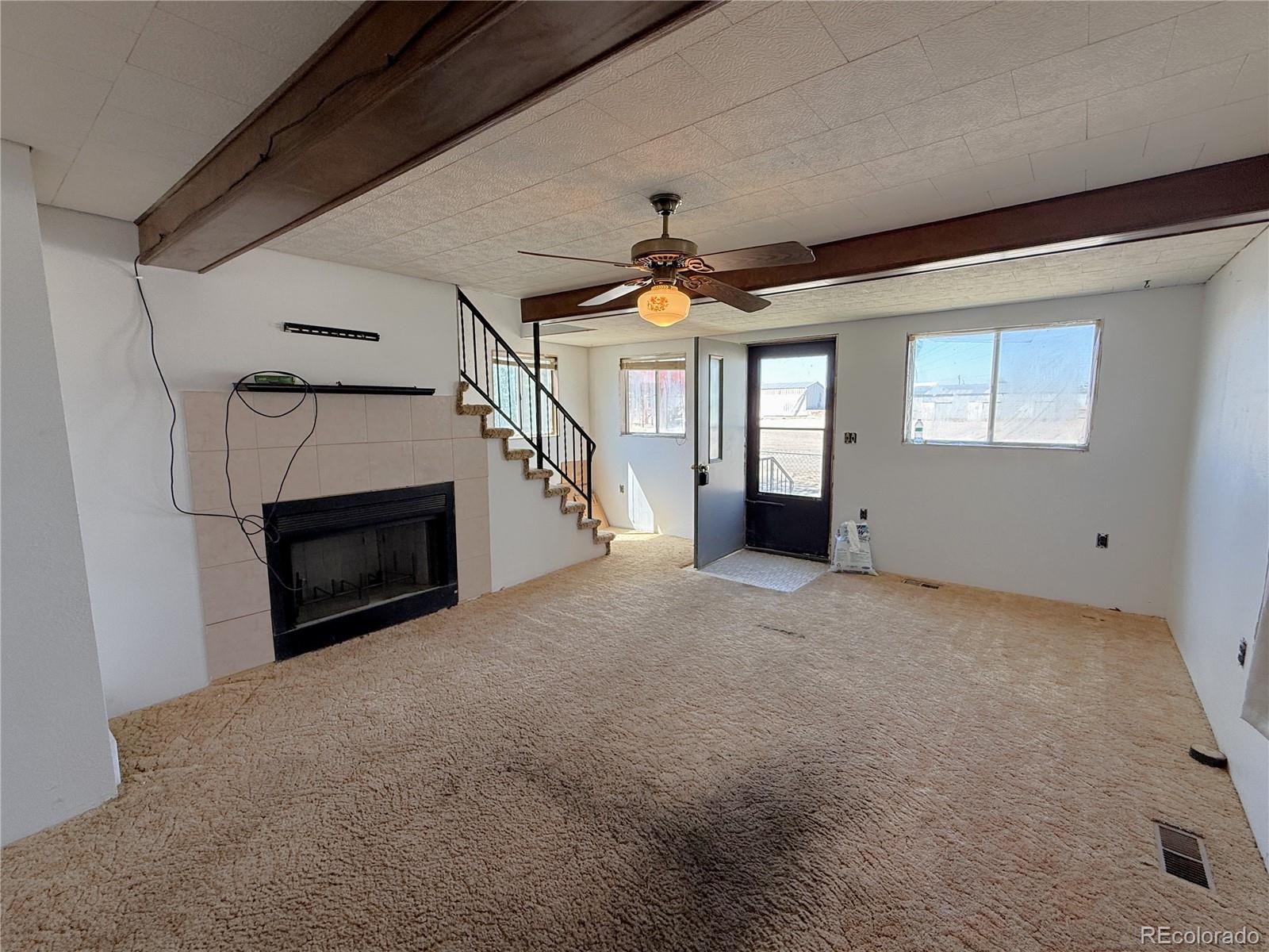 426 3rd Street Hugo, CO 80821 - Photo 5 of 34 a view of empty room with fireplace and windows