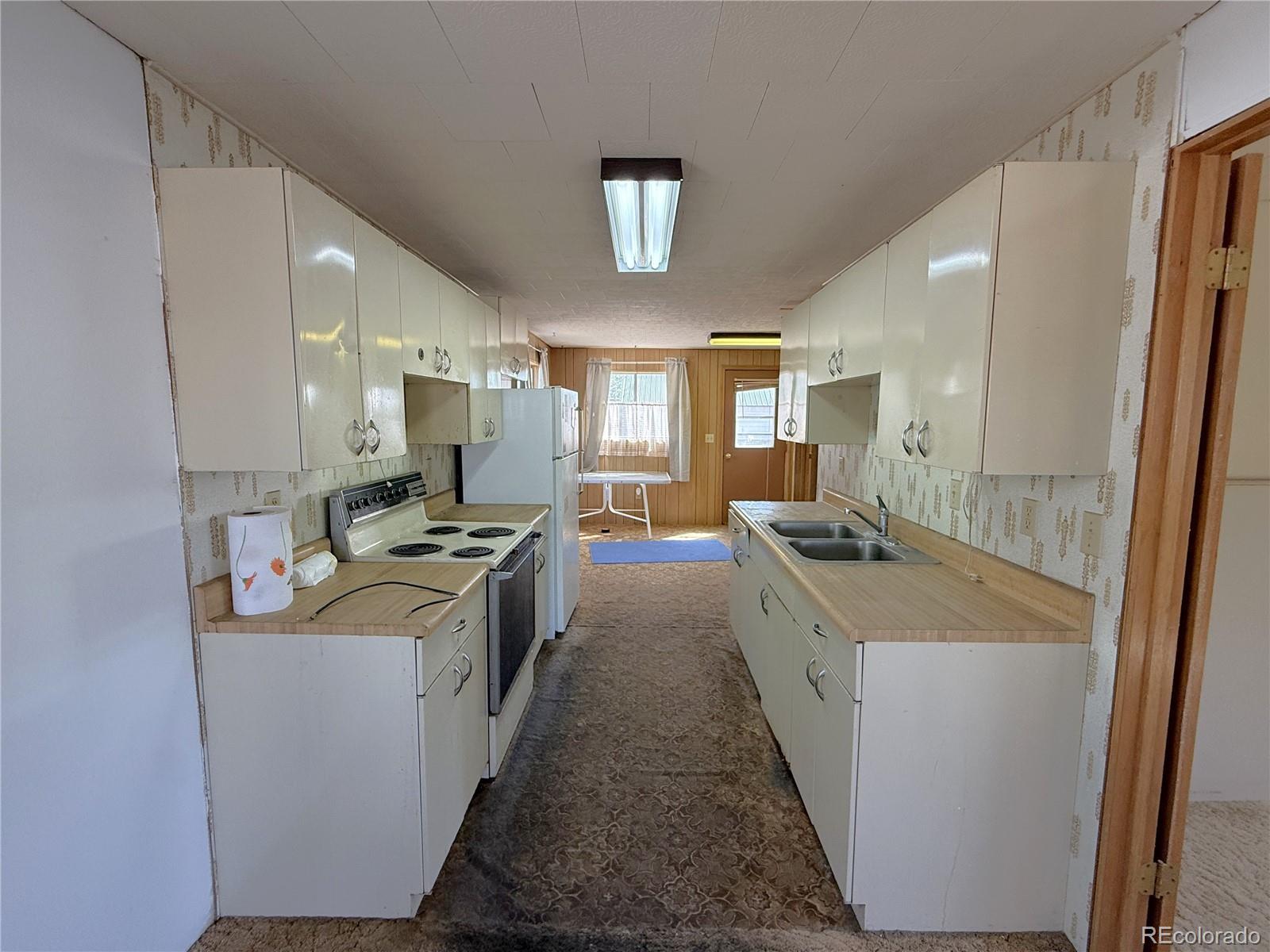 426 3rd Street Hugo, CO 80821 - Photo 6 of 34 a kitchen with a stove and cabinets