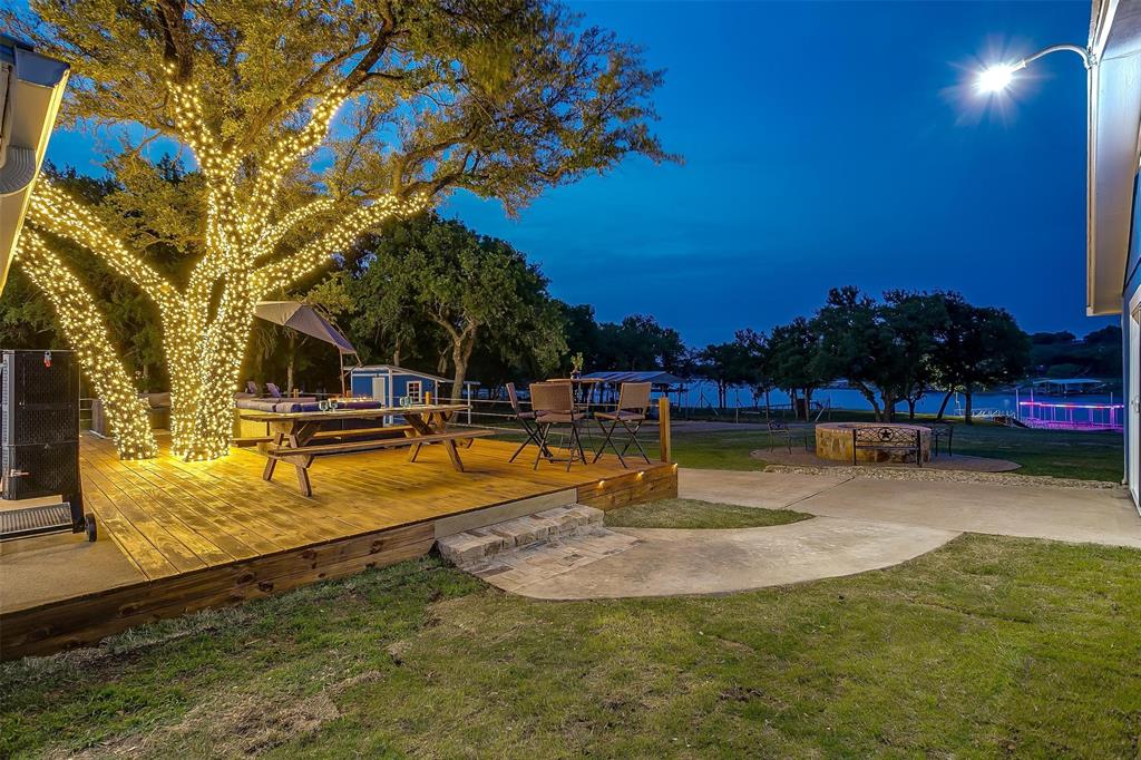 520 Deer Trail Gordon, TX 76453 - Photo 37 of 40 View of green lawn featuring a wooden deck and a patio area