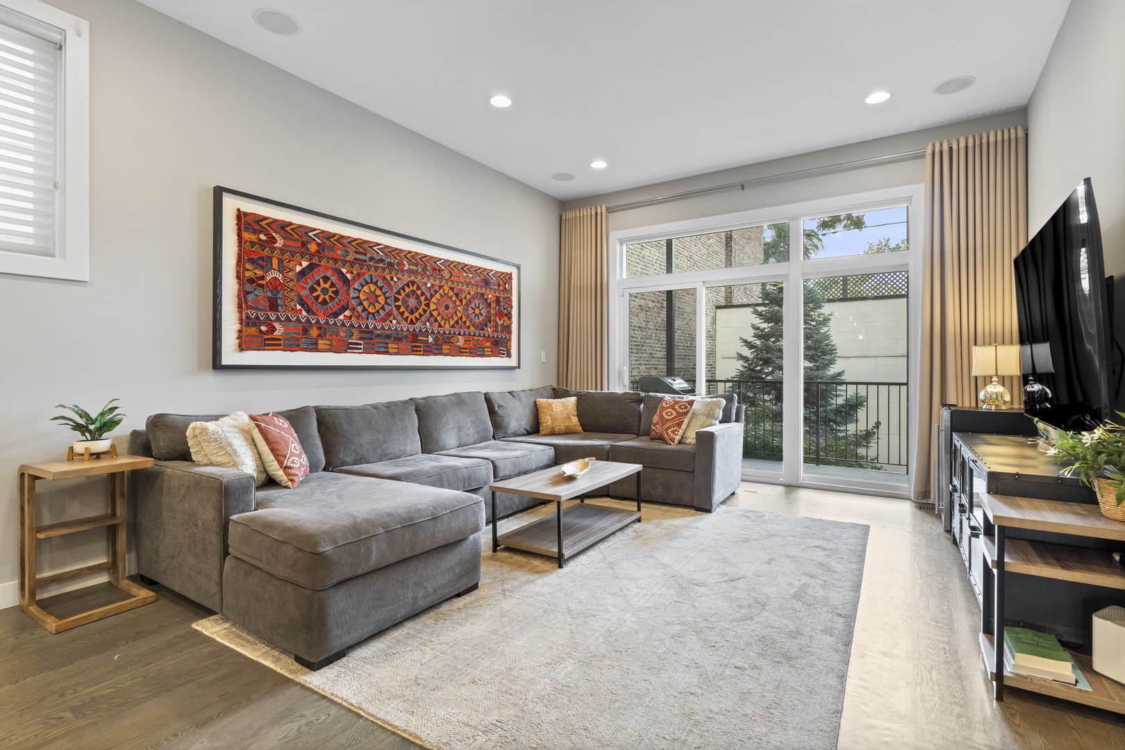 878 North Marshfield Avenue, Unit 1 Chicago, IL 60622 - Photo 13 of 26 a living room with furniture a flat screen tv and floor to ceiling window