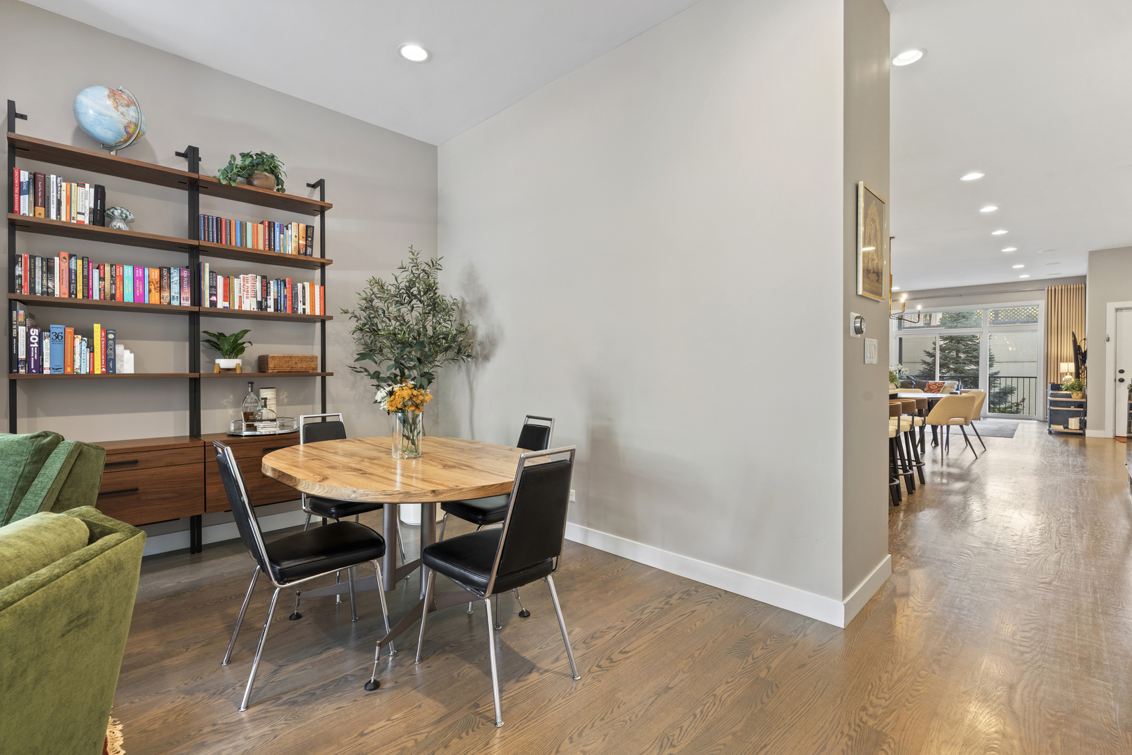 878 North Marshfield Avenue, Unit 1 Chicago, IL 60622 - Photo 6 of 26 a view of a dining room with furniture and a book shelf