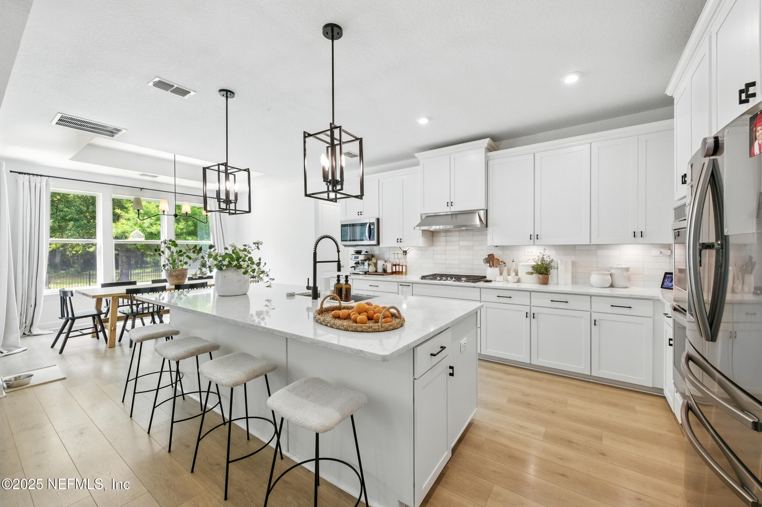 177 Windwalker Drive St. Augustine, FL 32092 - Photo 11 of 30 a kitchen with stainless steel appliances kitchen island granite countertop a stove a sink and a refrigerator