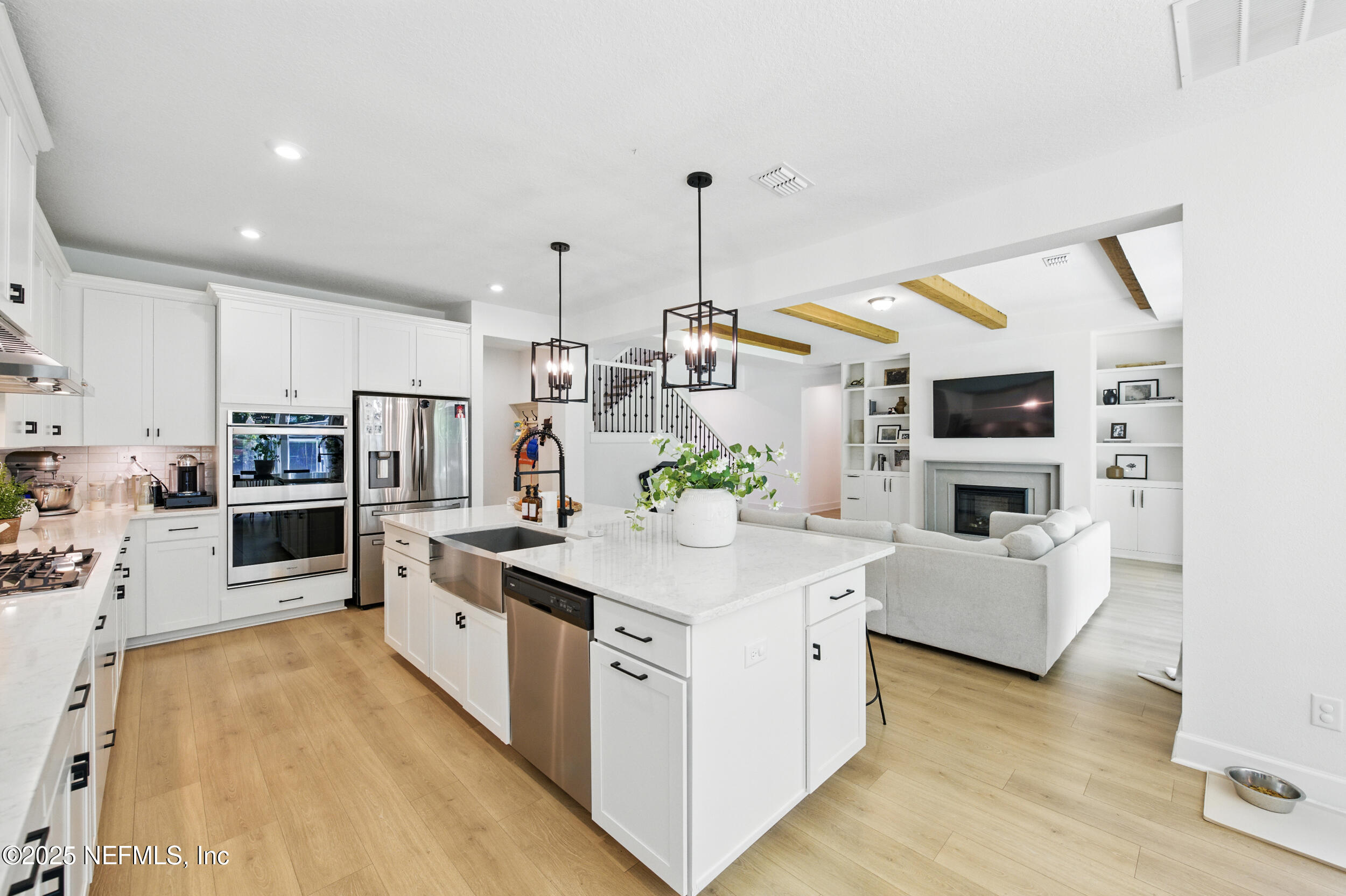 177 Windwalker Drive St. Augustine, FL 32092 - Photo 12 of 30 a kitchen with cabinets and wooden floor