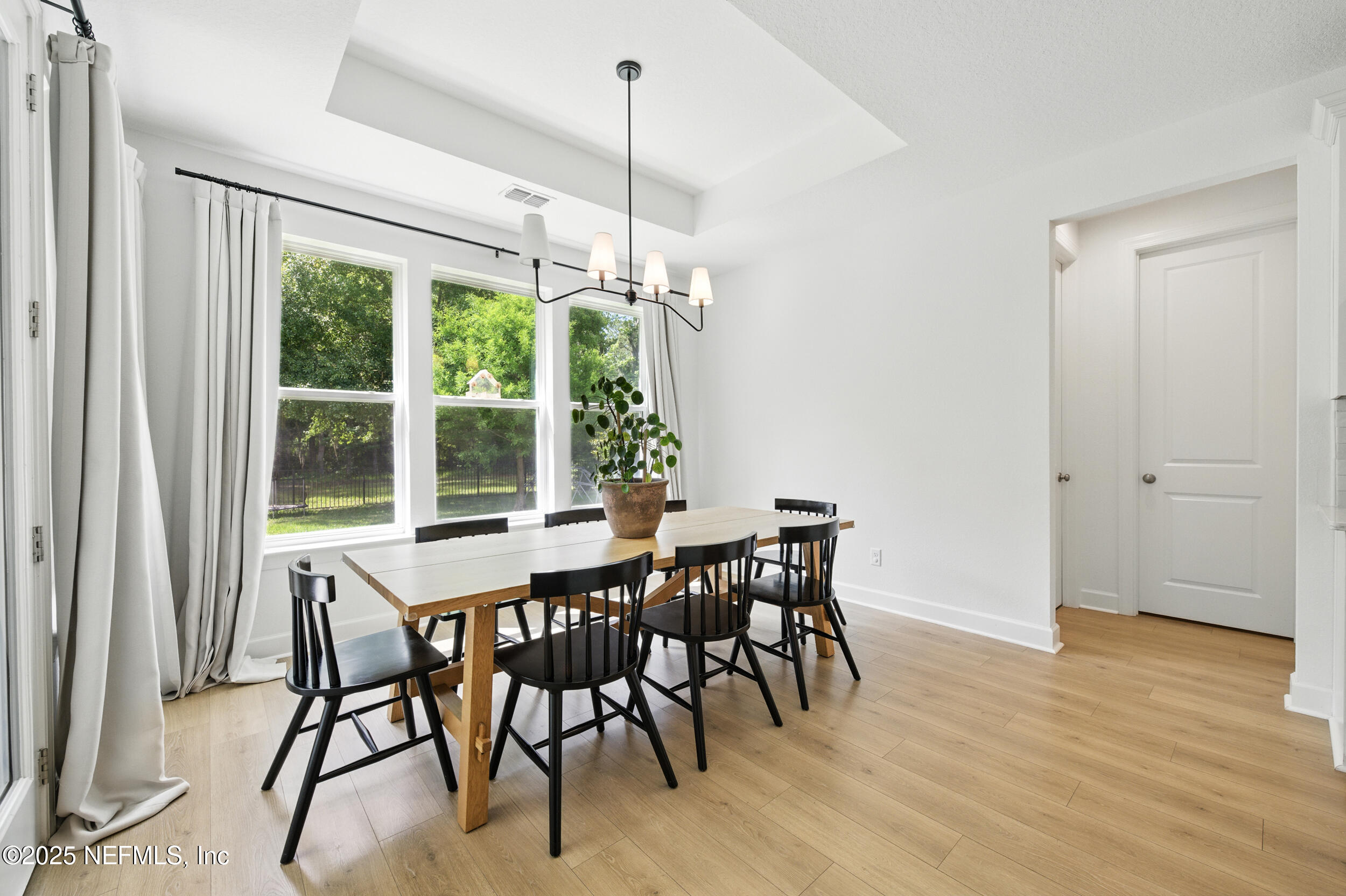 177 Windwalker Drive St. Augustine, FL 32092 - Photo 13 of 30 a view of a dining room with furniture window and wooden floor