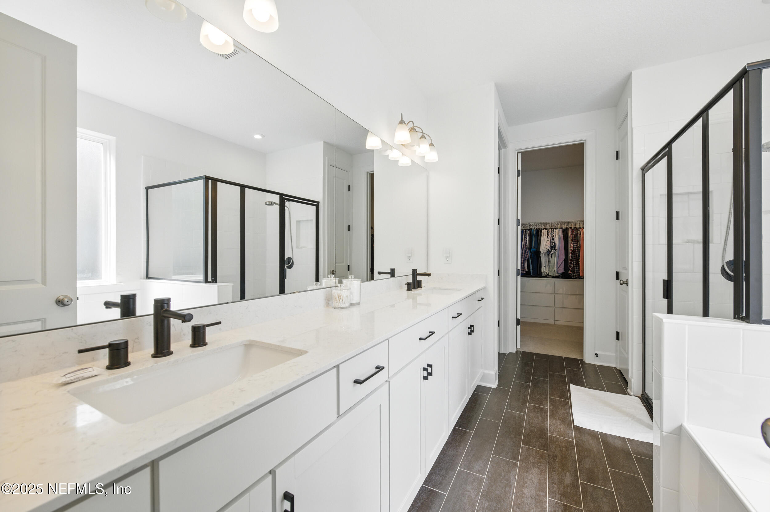 177 Windwalker Drive St. Augustine, FL 32092 - Photo 17 of 30 a bathroom with a double vanity sink mirror double and shower