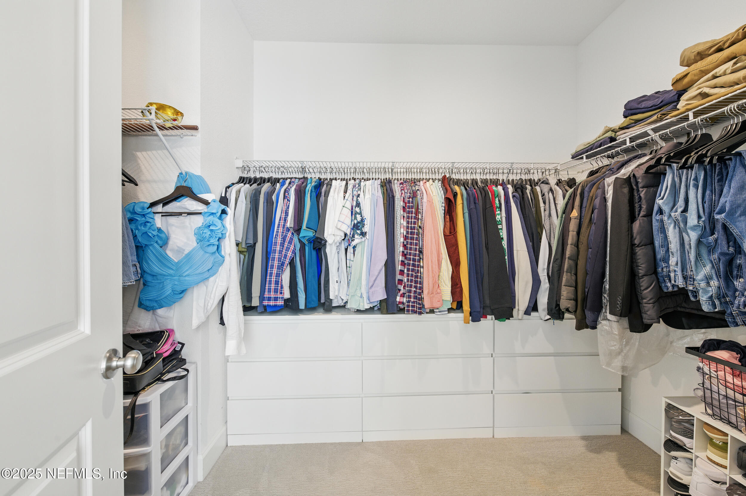 177 Windwalker Drive St. Augustine, FL 32092 - Photo 20 of 30 a view of walk in closet with clothes and shoes