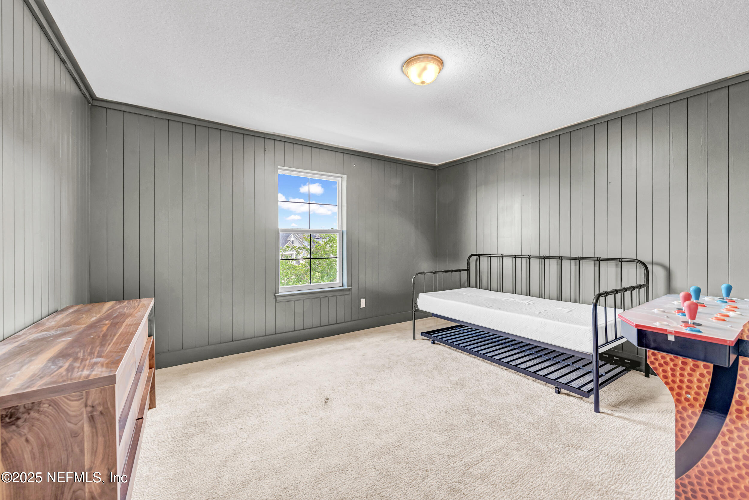177 Windwalker Drive St. Augustine, FL 32092 - Photo 23 of 30 a spacious bedroom with a bed and a window