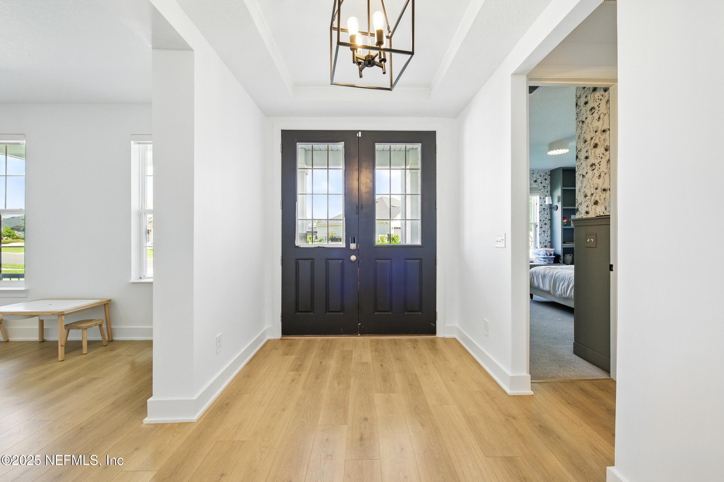 177 Windwalker Drive St. Augustine, FL 32092 - Photo 6 of 30 a view of hallway with livingroom and wooden floor