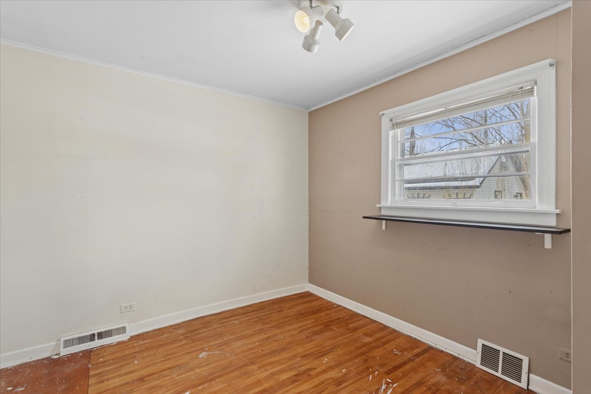 11333 72nd Street Burr Ridge, IL 60527 - Photo 16 of 32 a view of an empty room with wooden floor and a window