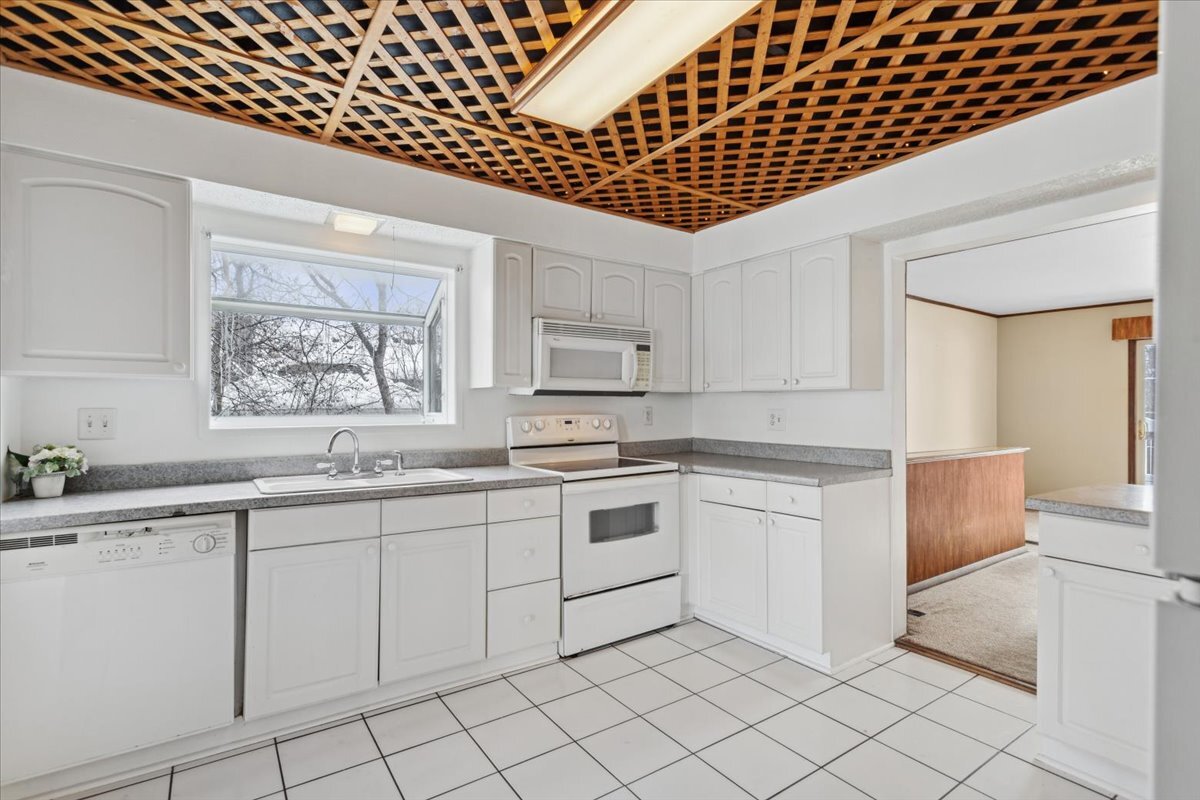 11333 72nd Street Burr Ridge, IL 60527 - Photo 5 of 32 a kitchen with granite countertop white cabinets and white appliances