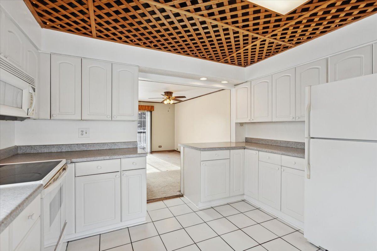 11333 72nd Street Burr Ridge, IL 60527 - Photo 6 of 32 a kitchen with white cabinets and white appliances