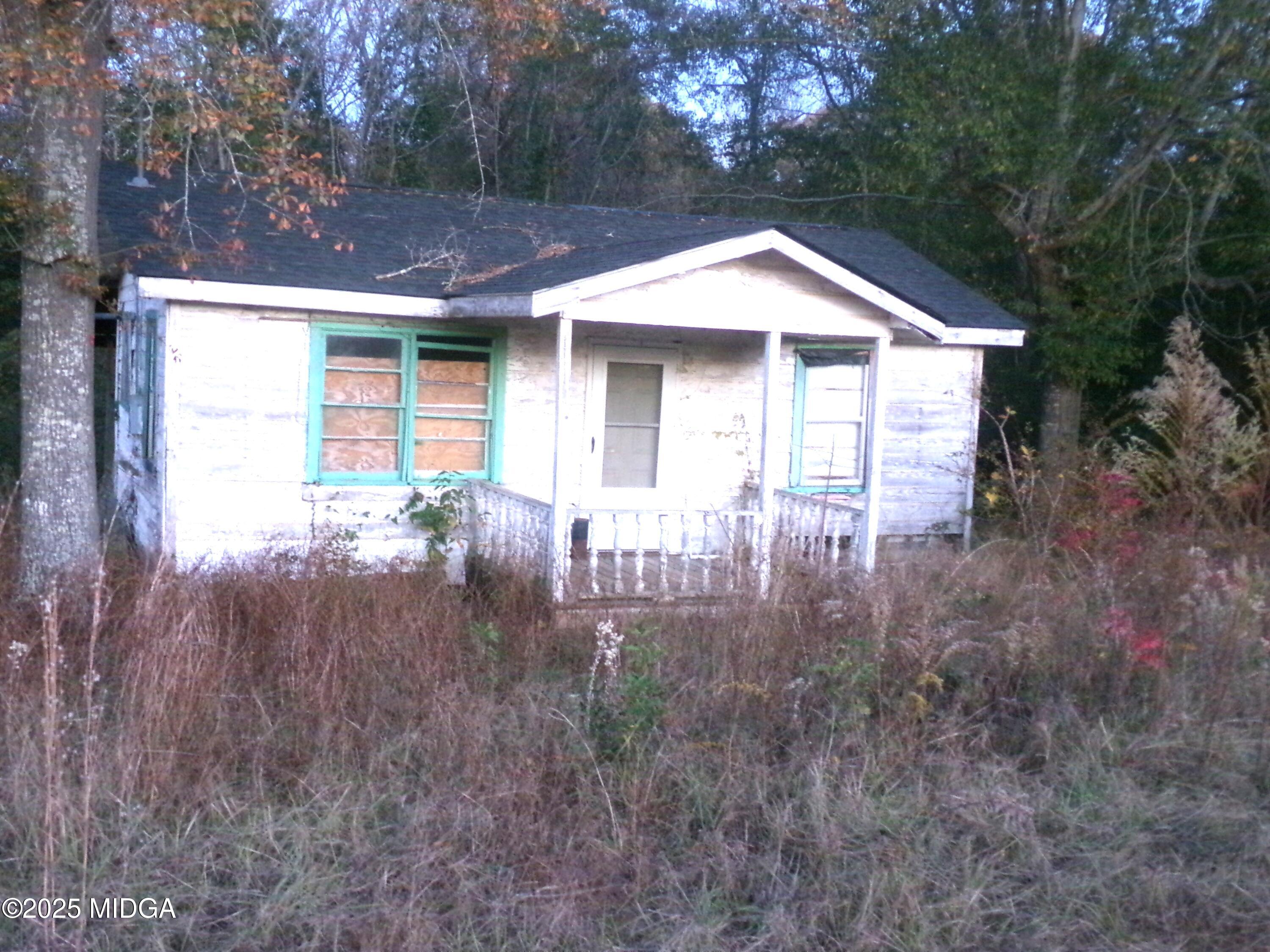 a front view of a house with yard and trees