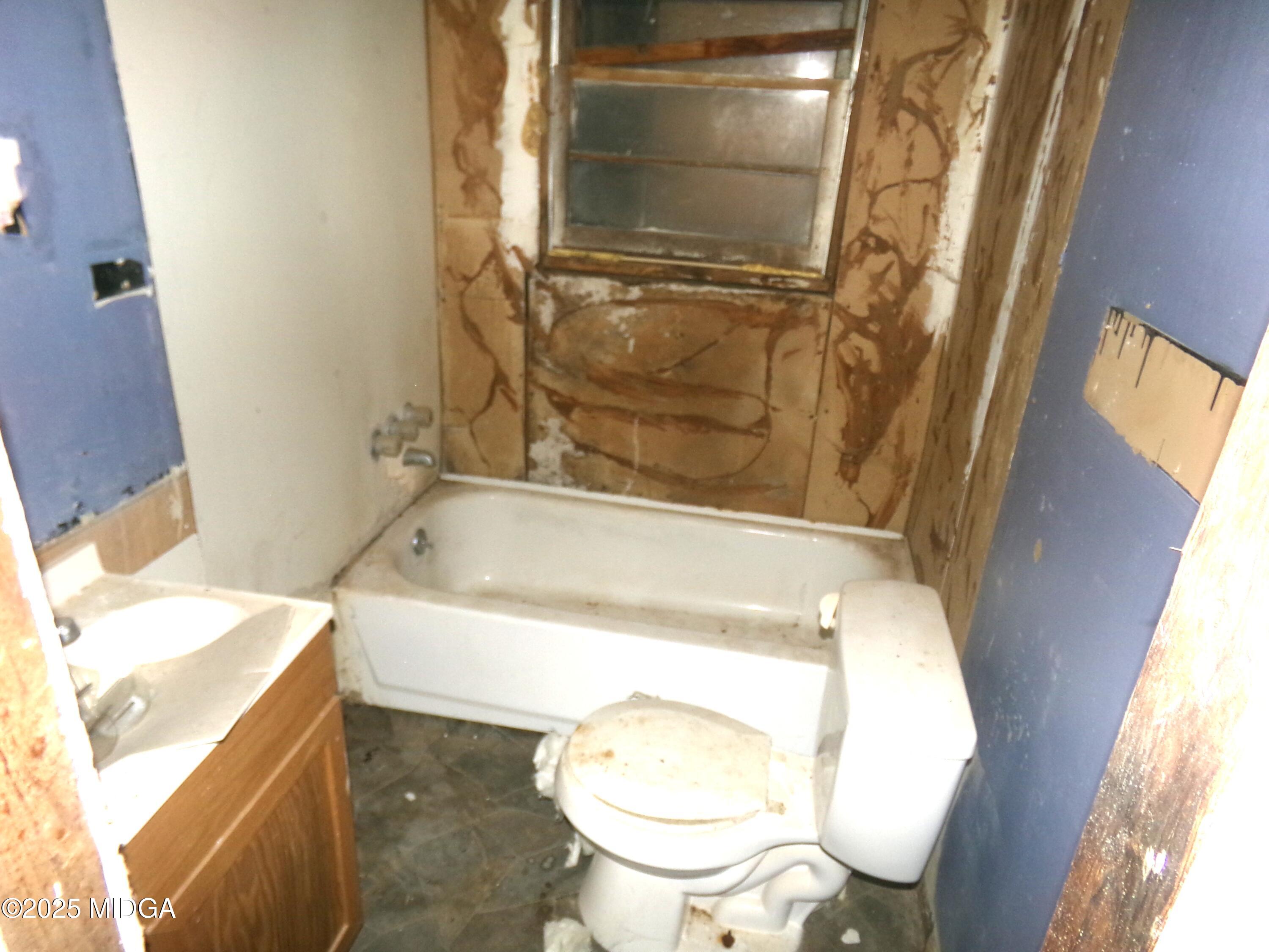 58 Strawberry Road Dry Branch, GA 31020 - Photo 6 of 10 a bathroom with a sink toilet and shower