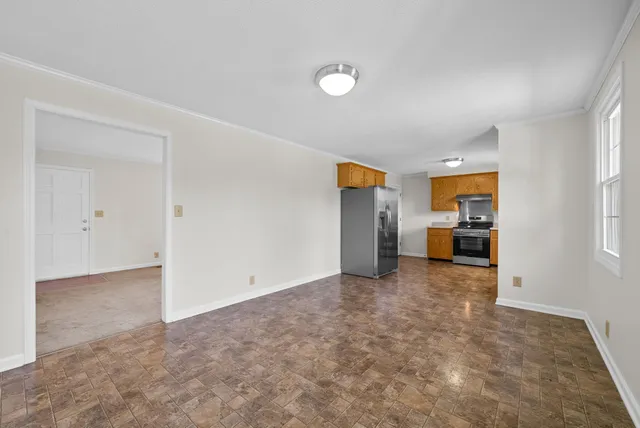 an empty room with closet and windows