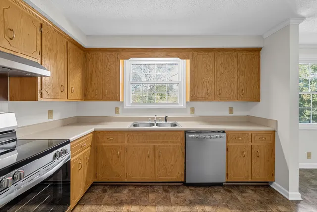 a kitchen with a sink stove and cabinets