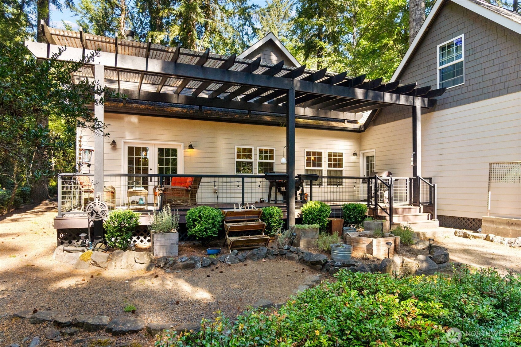 1130 East Sunset Hill Road Shelton, WA 98584 - Photo 37 of 40 a view of a patio with table and chairs under an umbrella
