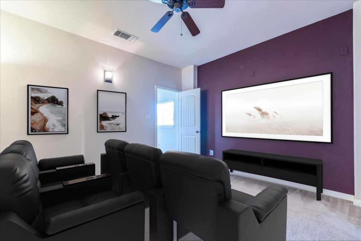 a media room with lots of chairs and a projector