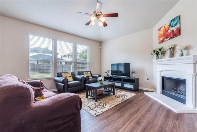 a living room with furniture a fireplace and a flat screen tv