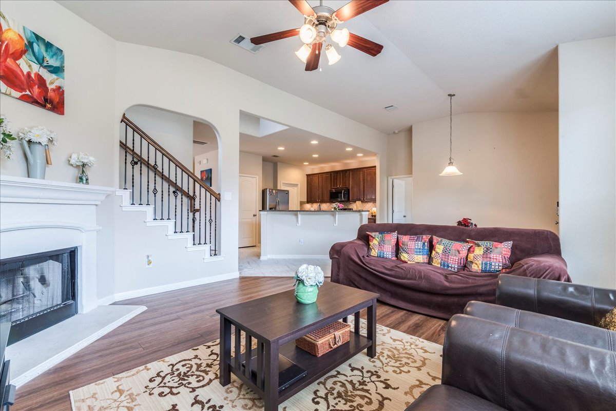 18628 Wind Valley Way Pflugerville, TX 78660 - Photo 11 of 33 a living room with furniture and kitchen view