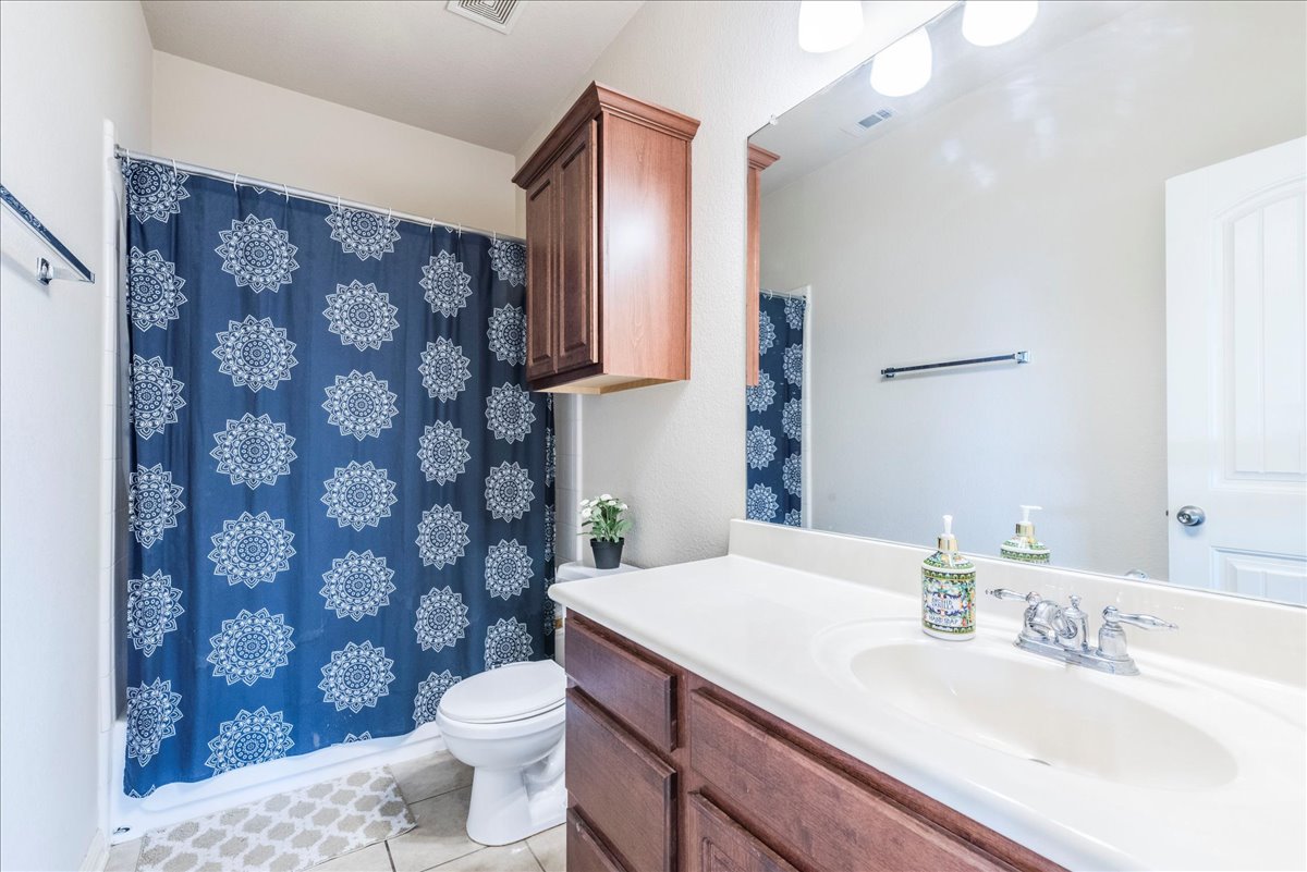 18628 Wind Valley Way Pflugerville, TX 78660 - Photo 21 of 33 a bathroom with a sink a toilet and a mirror