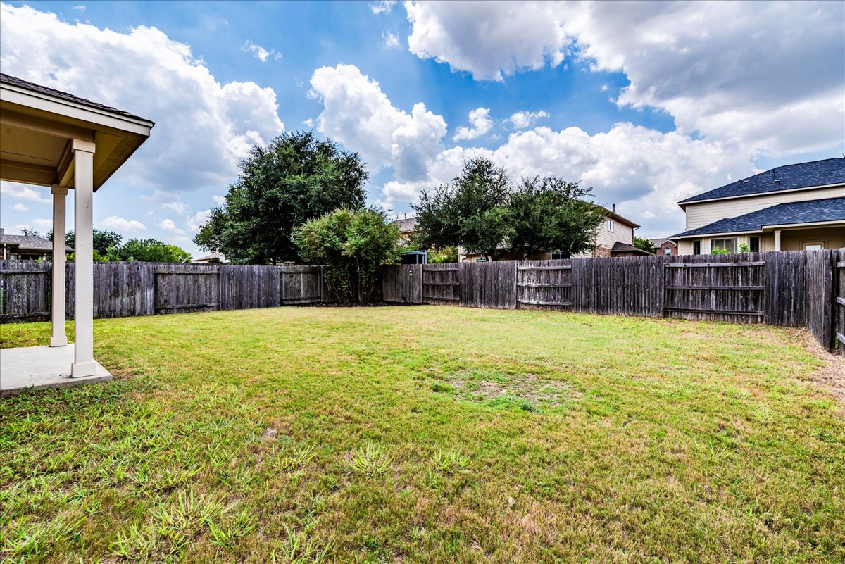 18628 Wind Valley Way Pflugerville, TX 78660 - Photo 22 of 33 a swimming pool with yard in the background