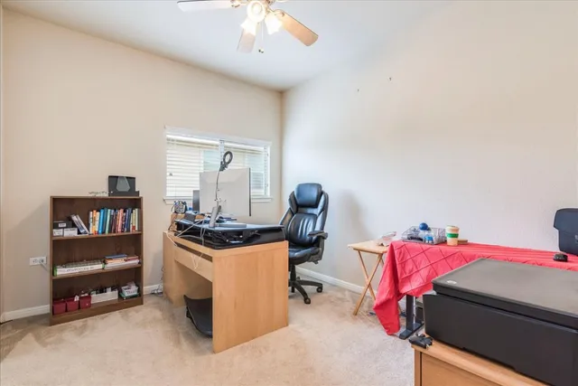 a view of bedroom with workspace and windows