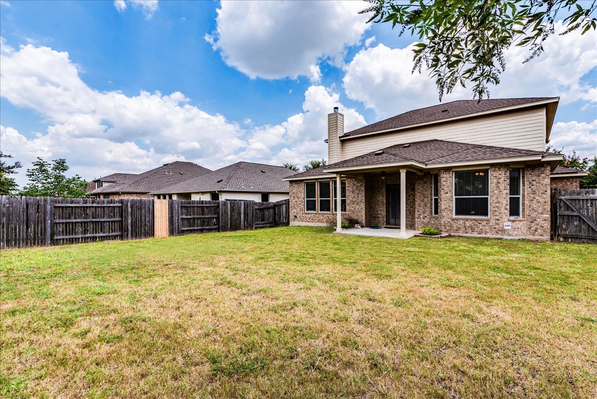 18628 Wind Valley Way Pflugerville, TX 78660 - Photo 24 of 33 a front view of a house with a garden