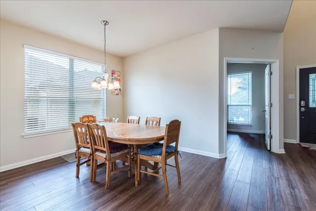a view of a dining room with furniture window and wooden floor
