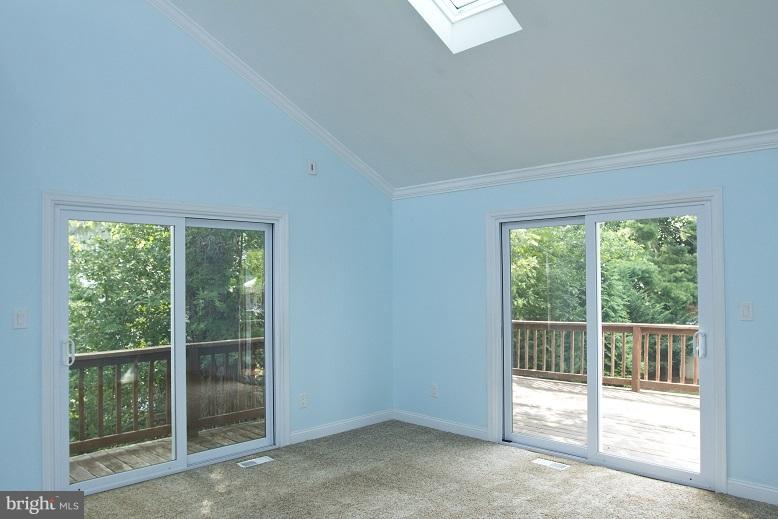 680 Red Cedar Road Annapolis, MD 21409 - Photo 4 of 30 a view of an empty room with wooden floor and windows
