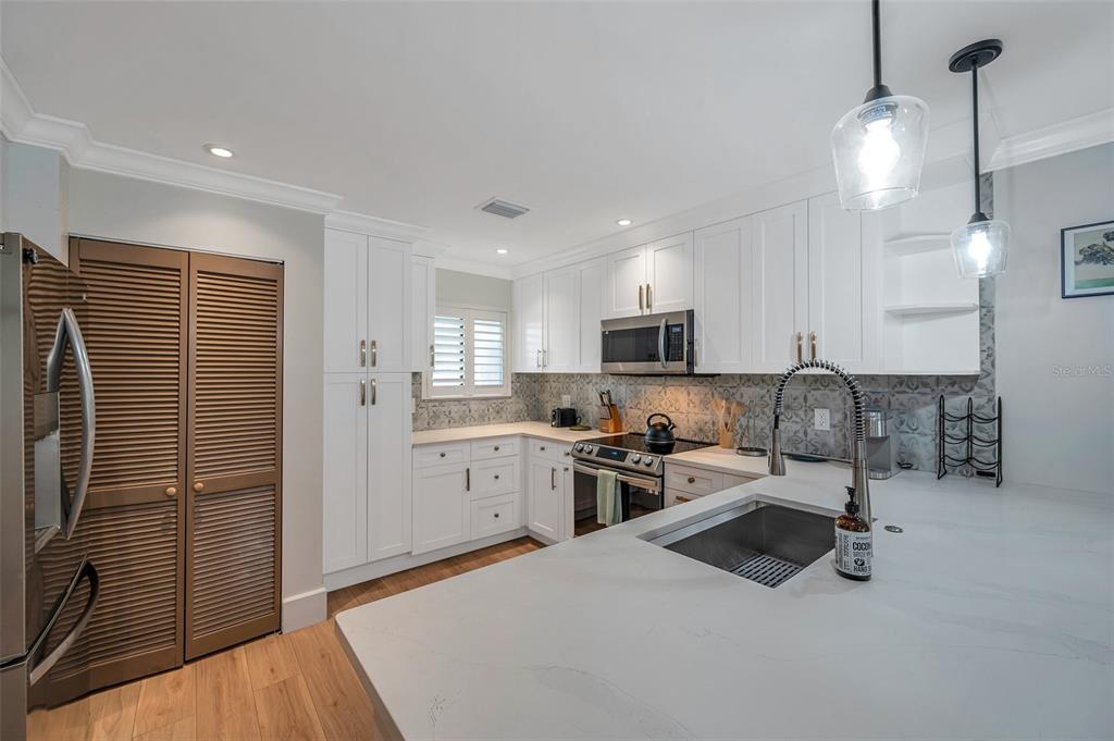29147 Bay Hollow Drive, Unit 3224 Wesley Chapel, FL 33543 - Photo 14 of 89 a kitchen with stainless steel appliances a refrigerator sink and microwave