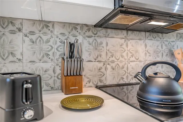 a living room with furniture and painting on the wall