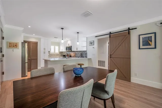 a bedroom with a bed and a view of kitchen