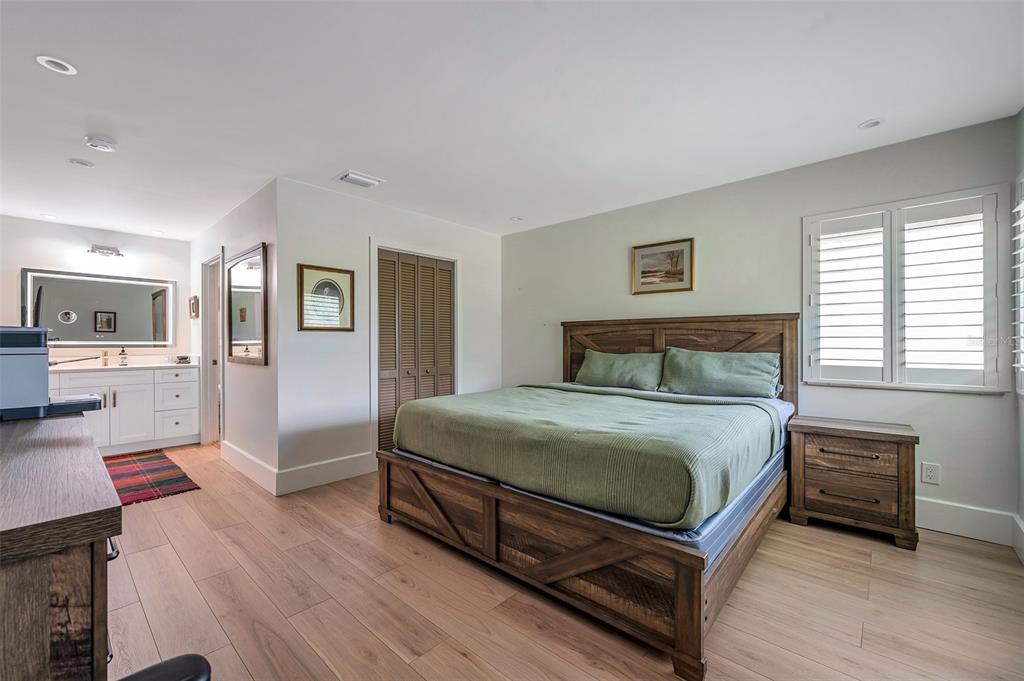 29147 Bay Hollow Drive, Unit 3224 Wesley Chapel, FL 33543 - Photo 30 of 89 a bedroom with a bed and a view of kitchen