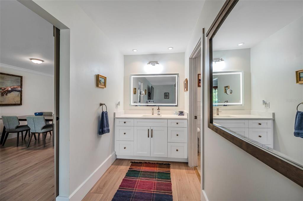 29147 Bay Hollow Drive, Unit 3224 Wesley Chapel, FL 33543 - Photo 36 of 89 a spacious bathroom with a sink mirror and toilet