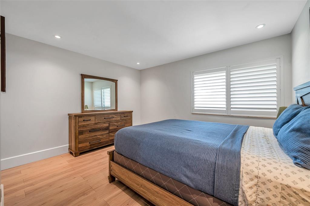 29147 Bay Hollow Drive, Unit 3224 Wesley Chapel, FL 33543 - Photo 43 of 89 a bedroom with a bed and wooden floor