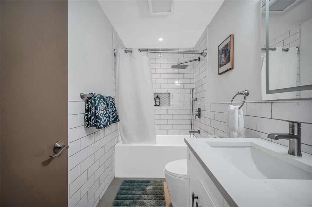 29147 Bay Hollow Drive, Unit 3224 Wesley Chapel, FL 33543 - Photo 45 of 89 a bathroom with a sink toilet and shower