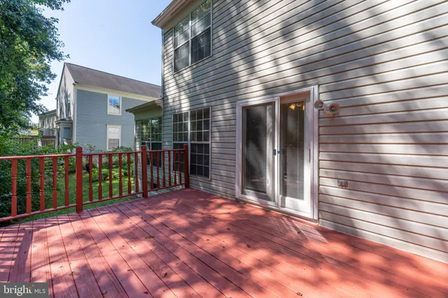 a view of backyard with deck and wooden floor