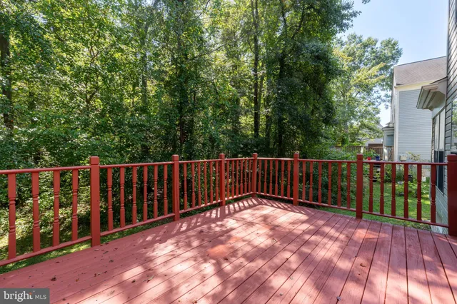 a view of backyard with deck and garden