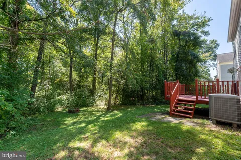 a view of backyard with barbeque oven and green space