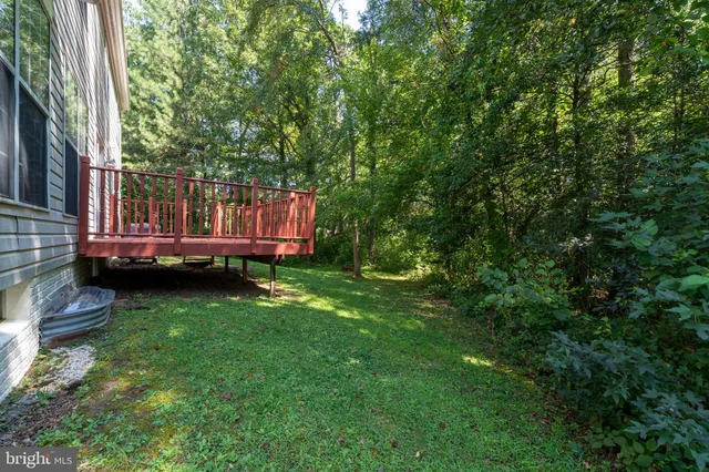 a backyard of a house with lots of green space and fountain