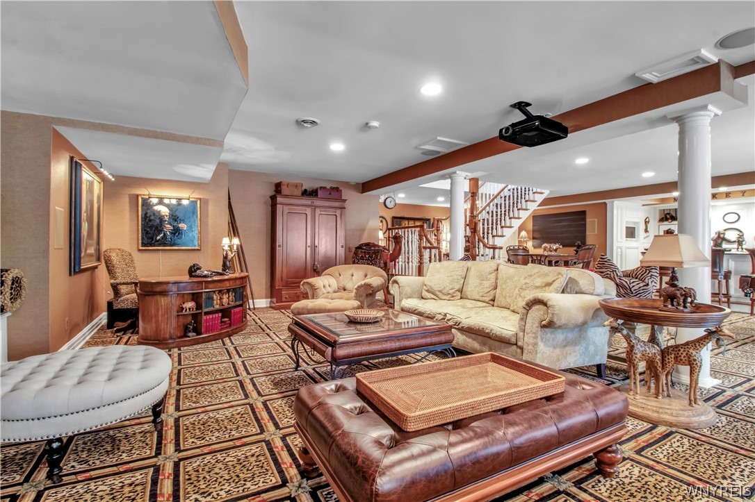 9590 Cobblestone Drive Clarence, NY 14031 - Photo 29 of 42 Lower level seating area and with screen projector