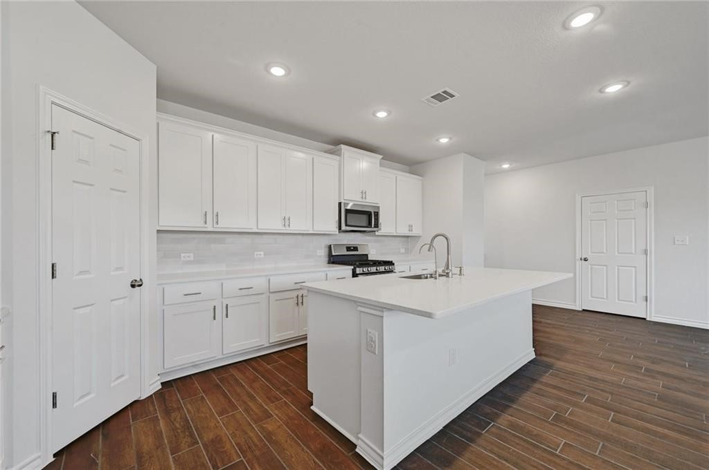 806 Pepperbark Loop Buda, TX 78610 - Photo 10 of 39 a view of a kitchen with electric appliances