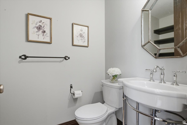 12317 Cypress Point Way Draper, UT 84020 - Photo 13 of 41 White porcelain pedestal sink with polished chrome fixtures and an octagonal framed mirror