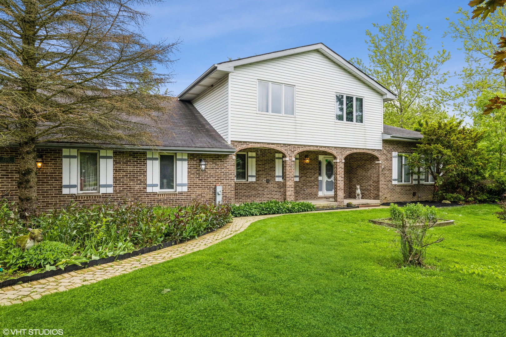 7305 West Pauling Road Monee, IL 60449 - Photo 1 of 27 a front view of a house with a yard and porch