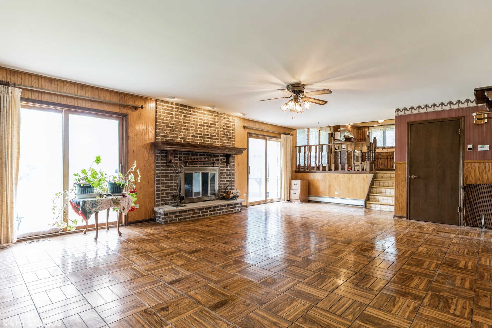 7305 West Pauling Road Monee, IL 60449 - Photo 14 of 27 a view of a livingroom with a fireplace a ceiling fan and front door