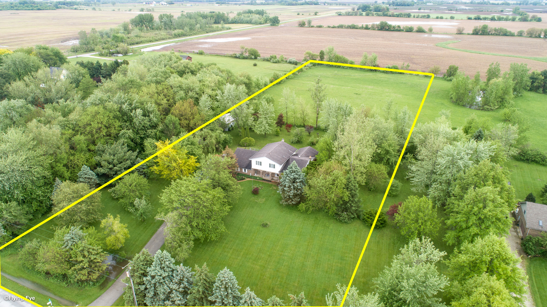 7305 West Pauling Road Monee, IL 60449 - Photo 3 of 27 a backyard of a house with lots of green space and lake view