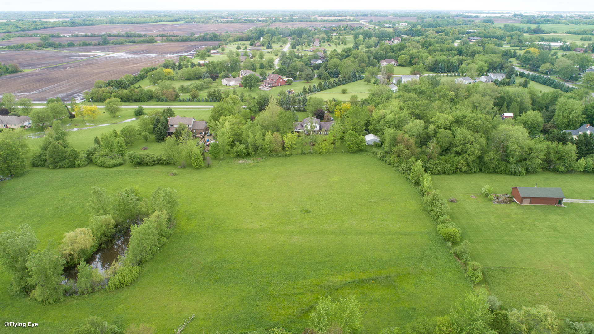 7305 West Pauling Road Monee, IL 60449 - Photo 7 of 27 a view of a green yard with a lake